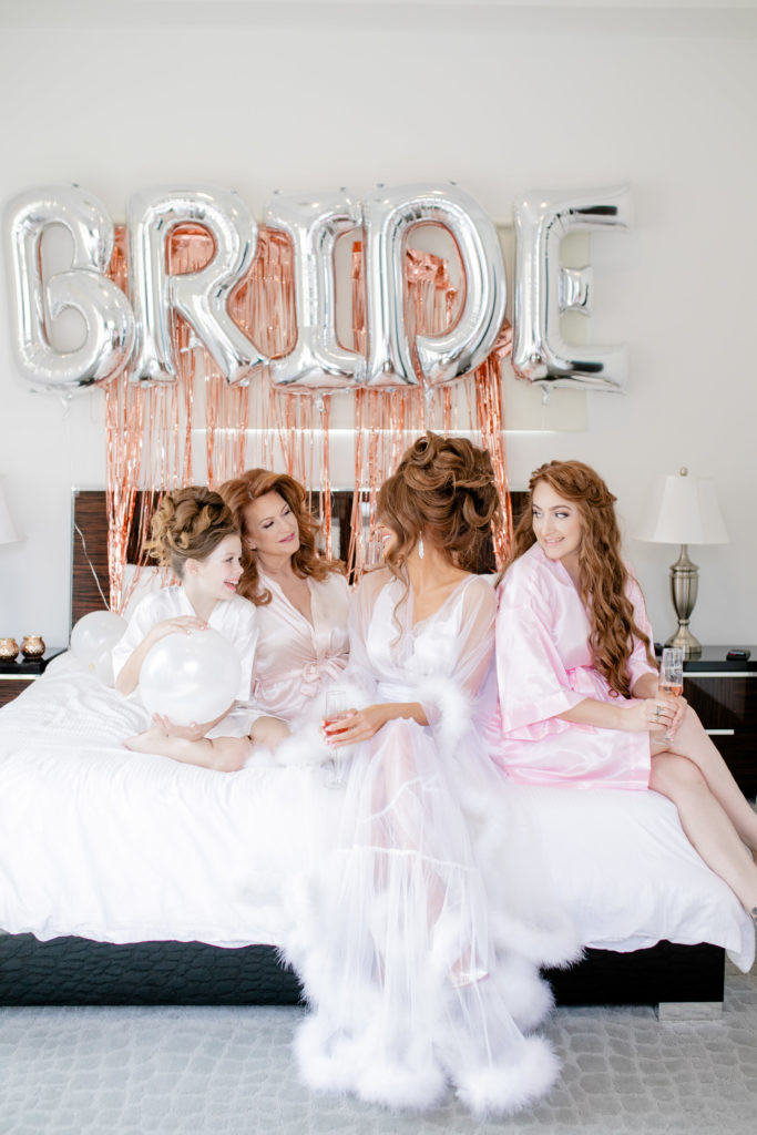 Bride and bridesmaids on bed