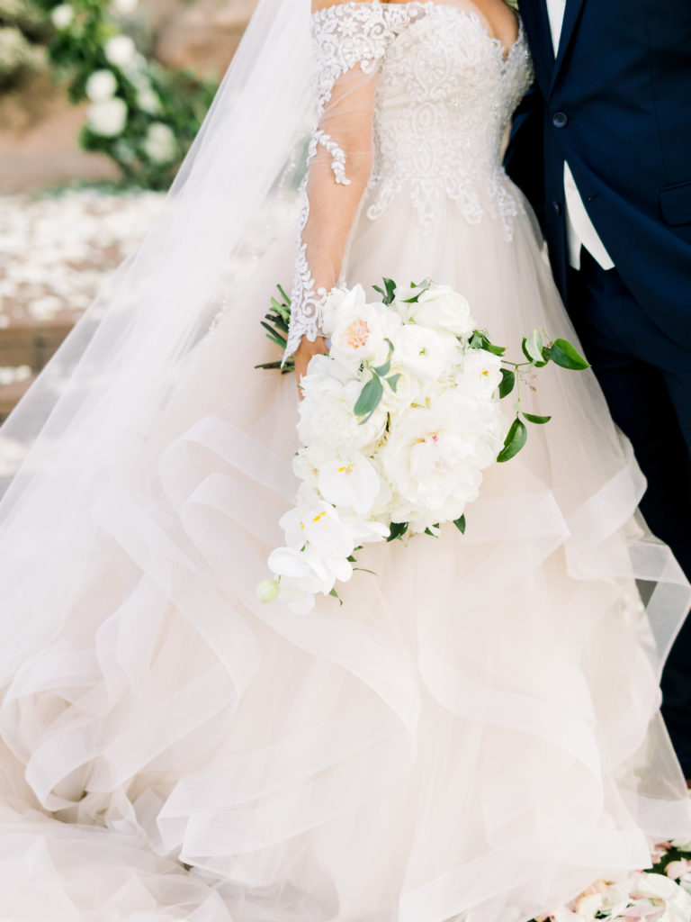 Wedding flowers against brides dress