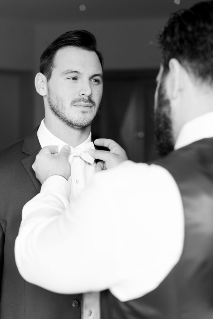 Groom getting ready fixing bowtie